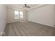 Spacious main bedroom features a tray ceiling, ceiling fan, and two large windows at 4991 Elaine Ct, Noblesville, IN 46062