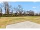 Large backyard offers ample space with lush green grass and partially bare trees in a serene setting at 6973 Oakdale Ln, Avon, IN 46123