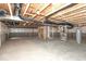 Unfinished basement featuring concrete floor, exposed ducts, support beams, and stairs to upper level at 6973 Oakdale Ln, Avon, IN 46123