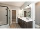 Bathroom featuring a double sink vanity, a shower with glass door, and neutral decor at 6973 Oakdale Ln, Avon, IN 46123