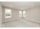 Bright bedroom with neutral carpet, three windows, and recessed lighting at 6973 Oakdale Ln, Avon, IN 46123