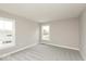 This bright bedroom features soft gray carpet, fresh paint, and natural light from two windows at 6973 Oakdale Ln, Avon, IN 46123