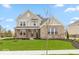 Charming two-story home with brick and siding exterior and beautifully landscaped front yard at 6973 Oakdale Ln, Avon, IN 46123
