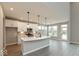 Modern kitchen with stainless appliances, island with pendant lighting and dining area at 6973 Oakdale Ln, Avon, IN 46123