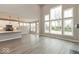 Open concept living room featuring large windows, hardwood floors and modern lighting at 6973 Oakdale Ln, Avon, IN 46123