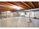 Unfinished basement with open ceiling, concrete floor and painted concrete block walls at 7330 Tousley Dr, Indianapolis, IN 46256