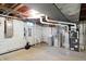 Unfinished basement with painted cinder block walls and mechanical equipment at 7330 Tousley Dr, Indianapolis, IN 46256
