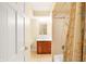 Bathroom featuring a shower-tub combo and wooden vanity with a ceramic tile floor at 7330 Tousley Dr, Indianapolis, IN 46256