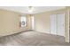 Bright bedroom with plush carpeting, ceiling fan and a convenient closet for optimal storage at 7330 Tousley Dr, Indianapolis, IN 46256