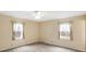 Neutral bedroom with plush carpeting, complemented by light-filled windows adorned with patterned curtains at 7330 Tousley Dr, Indianapolis, IN 46256
