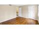 Inviting bedroom with classic hardwood floors, featuring an open closet and entry door at 7330 Tousley Dr, Indianapolis, IN 46256