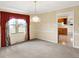 Cozy dining room with a window for natural light and an open doorway into an adjacent living space at 7330 Tousley Dr, Indianapolis, IN 46256