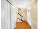 Inviting foyer with hardwood floors, staircase, and closet at 7330 Tousley Dr, Indianapolis, IN 46256