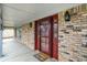 Close-up of an inviting front entrance featuring a storm door, brick accents, and a welcome mat at 7330 Tousley Dr, Indianapolis, IN 46256
