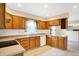 Bright kitchen featuring wood cabinets, white appliances, lots of counter space and tiled floor at 7330 Tousley Dr, Indianapolis, IN 46256
