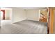 Spacious living room with neutral carpet, beige walls, and open view to other rooms in the home at 7330 Tousley Dr, Indianapolis, IN 46256