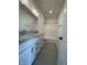 Well-lit bathroom with double vanity featuring granite countertops, modern fixtures, and tiled floors at 770 Leila Mae Ln, Westfield, IN 46074