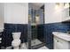 Modern bathroom with navy tile and glass shower at 1715 Union St, Indianapolis, IN 46225