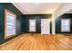 Spacious living room with hardwood floors and dark green walls at 1715 Union St, Indianapolis, IN 46225