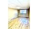 Unfinished basement with durable wood-look flooring and a single window for natural light at 2245 Wallace Ave, Columbus, IN 47201