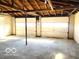 Unfinished garage interior with two doors and concrete flooring at 2245 Wallace Ave, Columbus, IN 47201