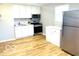 Bright kitchen with stainless steel appliances, white cabinetry, and light wood flooring at 2245 Wallace Ave, Columbus, IN 47201