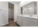 Well-lit bathroom boasts a double vanity, modern fixtures, and a view into the walk-in closet at 310 N Bur Oak Dr, Mooresville, IN 46158