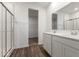 This modern bathroom features a double vanity, sleek shower, and access to a walk-in closet at 310 N Bur Oak Dr, Mooresville, IN 46158