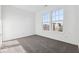Well-lit bedroom features a bright window, soft carpets, and freshly painted white walls at 310 N Bur Oak Dr, Mooresville, IN 46158