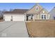 Charming single-Gathering home showcasing a three-car garage and manicured lawn at 310 N Bur Oak Dr, Mooresville, IN 46158