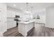 Modern kitchen with white cabinets, granite countertops, and stainless steel appliances at 310 N Bur Oak Dr, Mooresville, IN 46158
