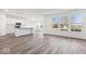 Open-concept kitchen with white cabinets, stainless steel appliances, and a large island at 310 N Bur Oak Dr, Mooresville, IN 46158