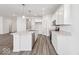 Well-lit kitchen featuring white cabinets, stainless steel appliances, and a large center island at 310 N Bur Oak Dr, Mooresville, IN 46158