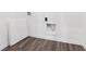 Functional laundry area features wood-look flooring and connections for a washer and dryer at 310 N Bur Oak Dr, Mooresville, IN 46158