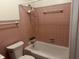 Bathroom featuring tiled walls, tub, and toilet at 6085 Manning Rd, Indianapolis, IN 46228