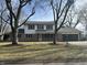 Charming two-story home featuring a brick and siding exterior, an attached garage, and a well-maintained front lawn at 6085 Manning Rd, Indianapolis, IN 46228