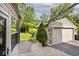 Attached garage featuring stone accents, a large backyard, and a concrete paver walkway at 6348 Kingsley Dr, Indianapolis, IN 46220