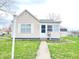Charming single-story home with light siding, neatly landscaped yard, and inviting front entrance at 810 W 2Nd St, Anderson, IN 46016