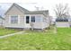 Charming home featuring light siding, a well-maintained lawn, and a classic front door with adjacent windows at 810 W 2Nd St, Anderson, IN 46016