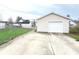 Single-car detached garage in backyard with an additional parking pad and a chain-link fenced yard at 810 W 2Nd St, Anderson, IN 46016
