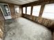 Spacious sun room featuring wood-look paneling and ample natural light from several large windows at 810 W 2Nd St, Anderson, IN 46016