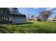 View of the backyard featuring a storage shed and a glimpse of the home's exterior at 965 W New Rd, Greenfield, IN 46140