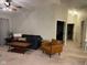 Spacious living room with a comfy couch and large TV at 9820 Legends Creek Dr # 208, Indianapolis, IN 46229
