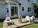 This backyard features a concrete patio with outdoor furniture, a space heater, and a view of the house at 11720 Grenadier Ln, Indianapolis, IN 46229