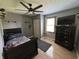 Charming bedroom with sports accents, a ceiling fan, and natural light at 11720 Grenadier Ln, Indianapolis, IN 46229