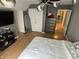 Bright bedroom with wood floors, ceiling fan, walk in closet, a chest of drawers, and access to another room at 11720 Grenadier Ln, Indianapolis, IN 46229