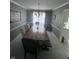 Spacious dining room with large table, elegant chandelier, and ample space for dinner parties at 11720 Grenadier Ln, Indianapolis, IN 46229