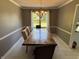 Formal dining room with a grand table and chairs set below a lovely chandelier at 11720 Grenadier Ln, Indianapolis, IN 46229