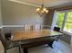 Bright dining area featuring a beautiful wood table set near a large, sunlit window at 11720 Grenadier Ln, Indianapolis, IN 46229