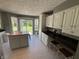 Updated kitchen boasting white cabinets, a wooden island and easy access to backyard at 11720 Grenadier Ln, Indianapolis, IN 46229
